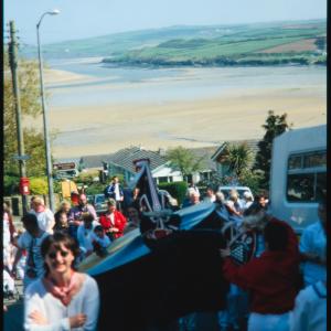 Old Oss walking up hill with view of sea in distance