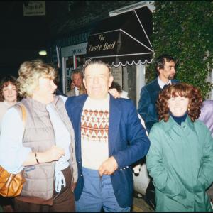 Crowd walking at night, people smiling