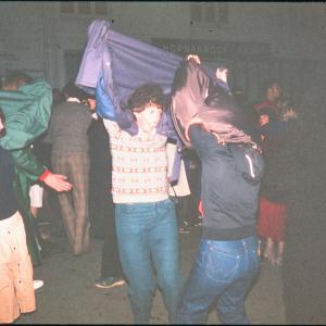 Night time, women pretending to tease with their jackets