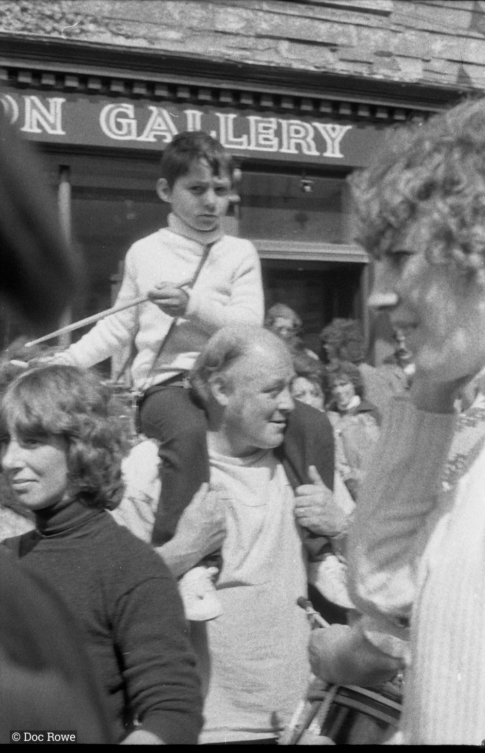 People and child playing the drum