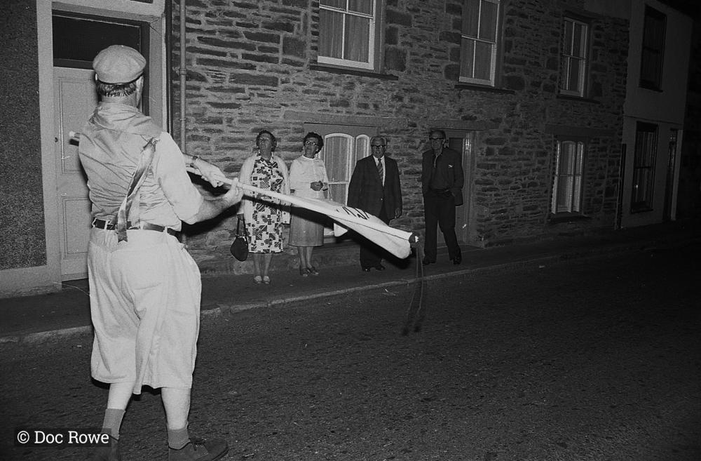 Merrymakers at night, locals watch