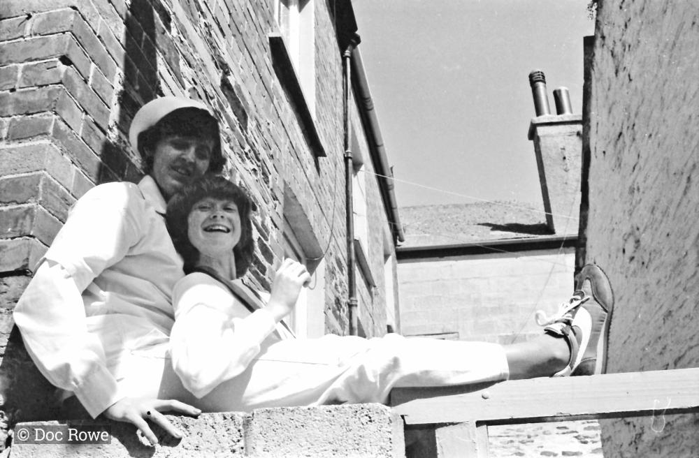 people sitting on wall