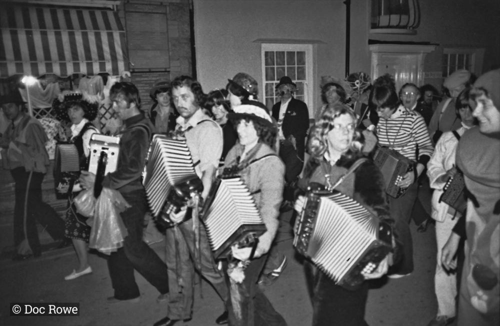 Musicians in parade on street at night