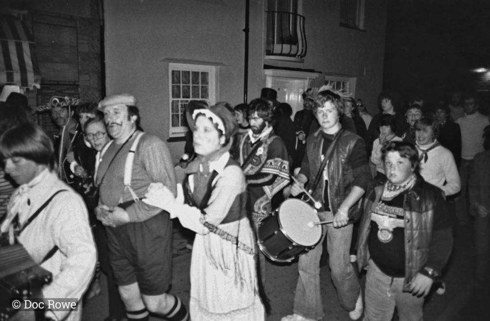 Musicians in parade on street at night