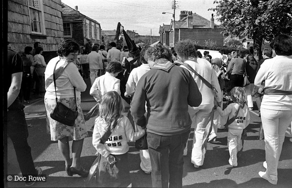 People walking behind Old Oss