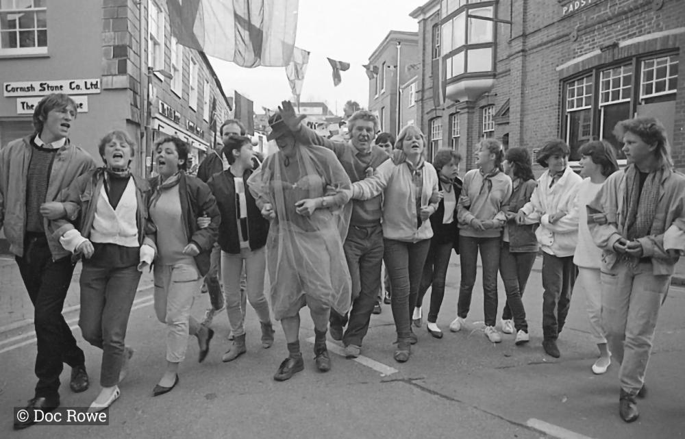 People walking down the street arm in arm