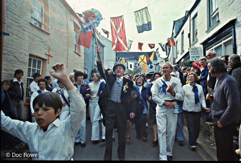 Blue Ribbon Oss Master of Ceremonies leading procession down street
