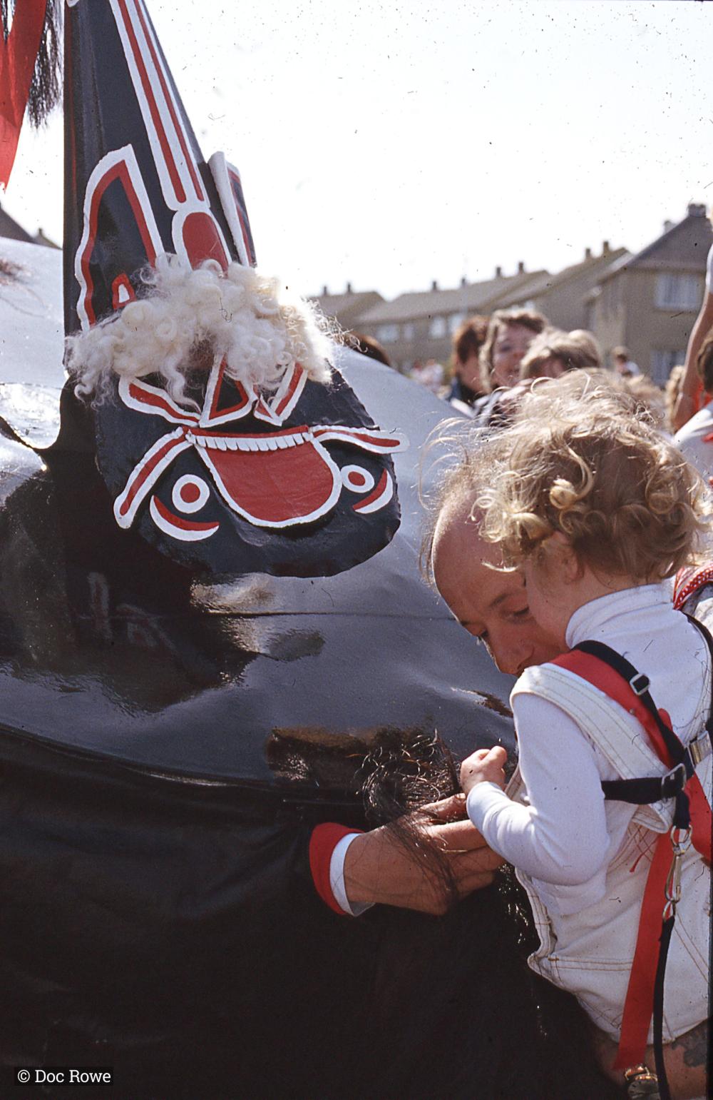 Old Oss shaking hands with child