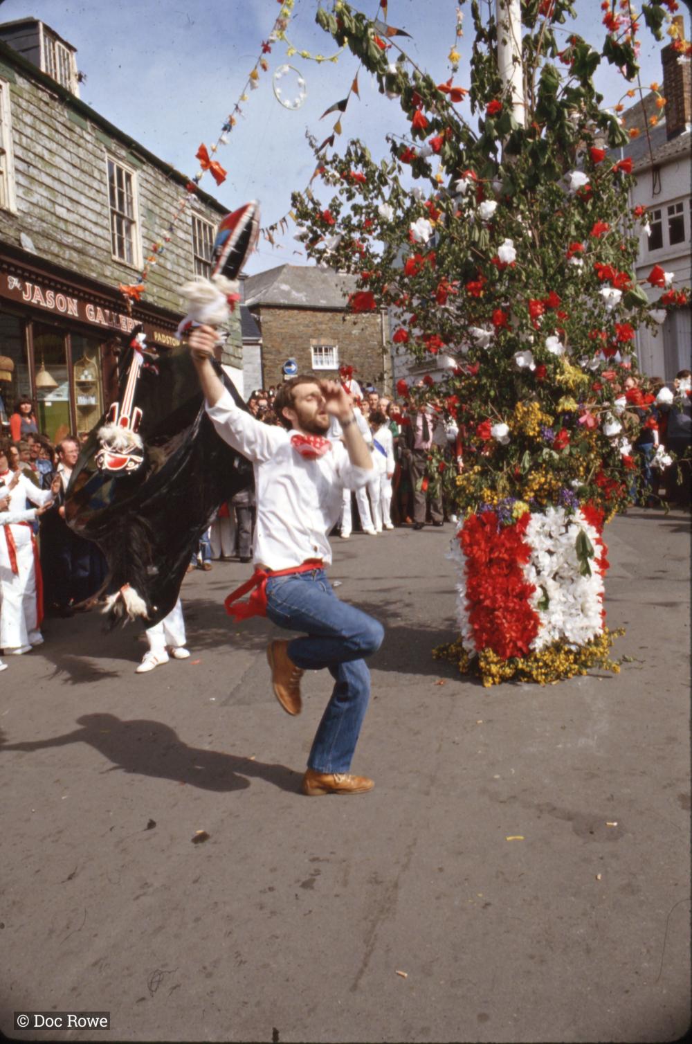Teaser dancing under Maypole