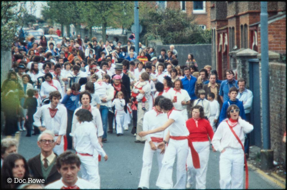 Old Oss party and crowd walking in street