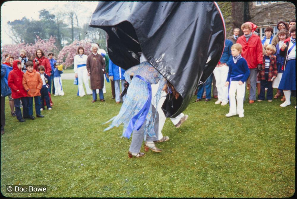 Man and woman's legs under Blue Ribbon Oss costume