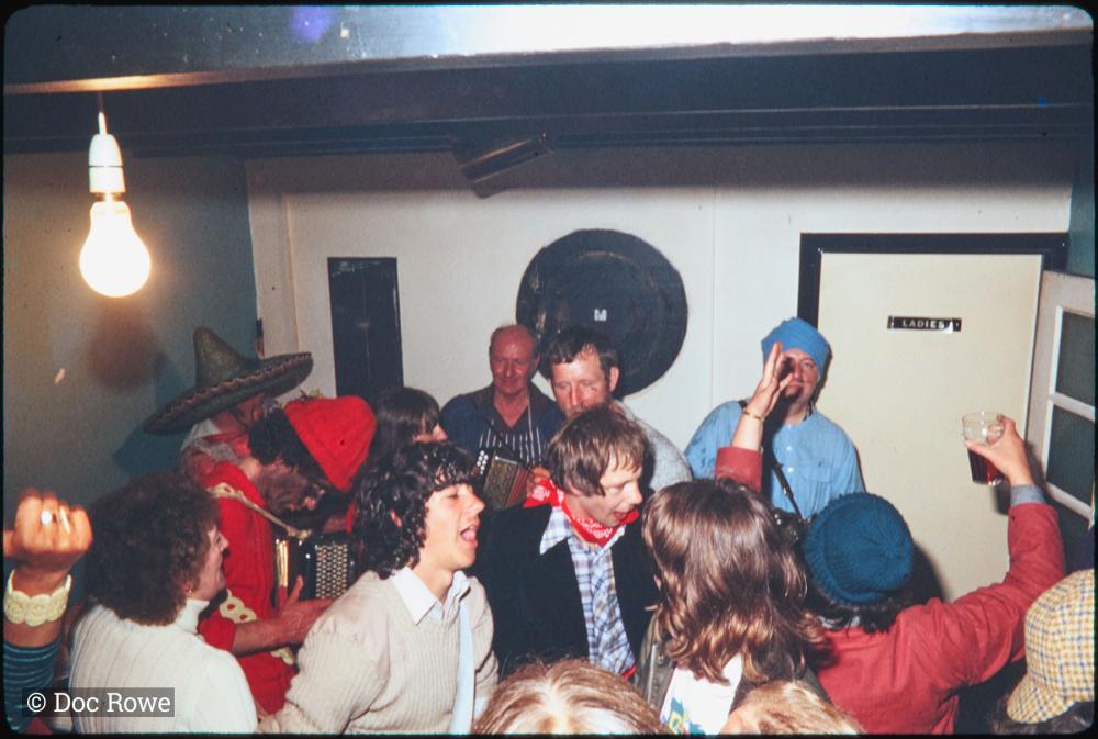 People dancing in pub in fancy dress