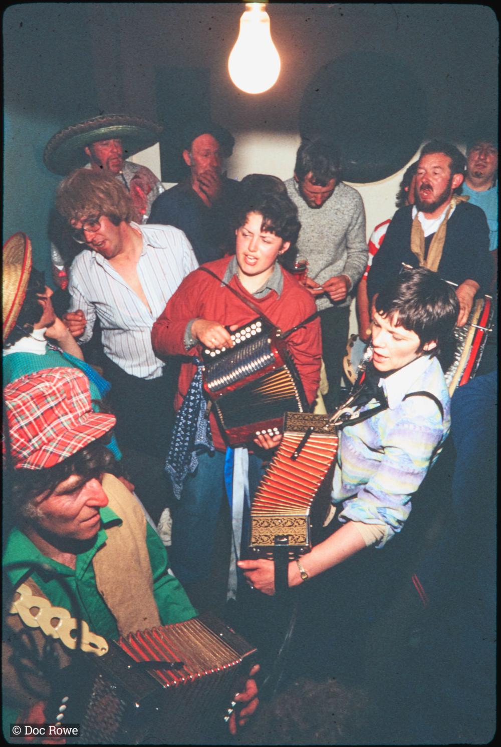 People dancing in pub in fancy dress