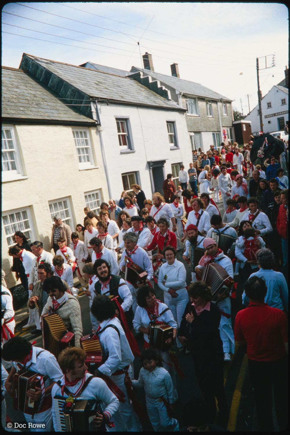 Old Oss procession walking along road