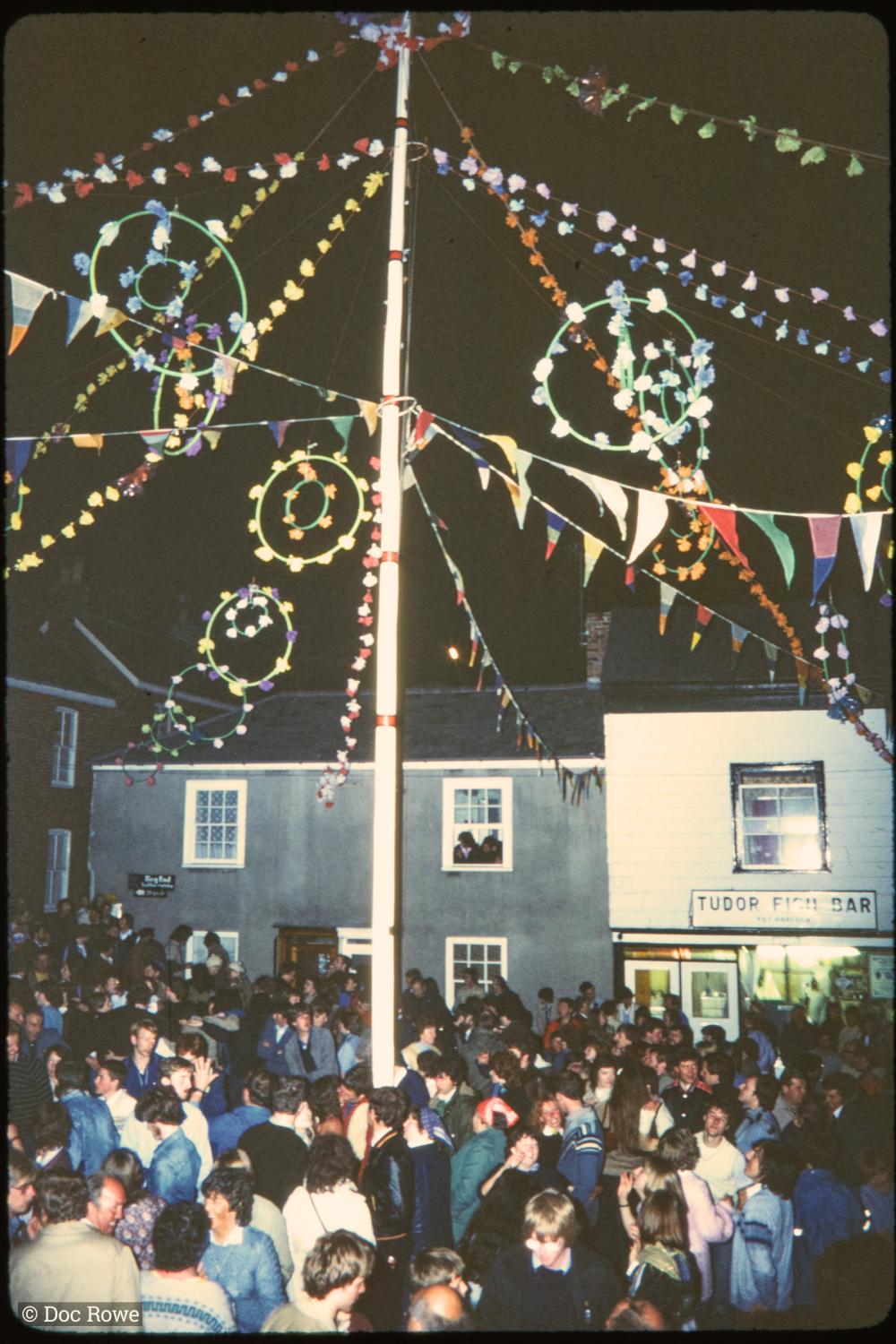 Maypole at night with crowd