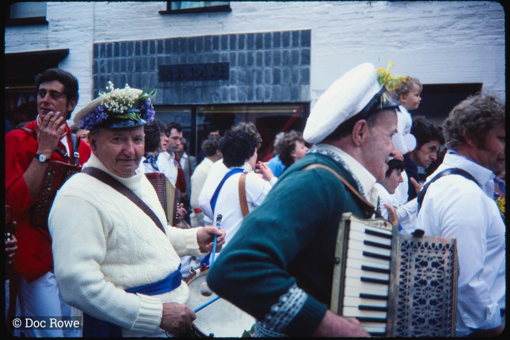 Men playing accordions and drums in procession