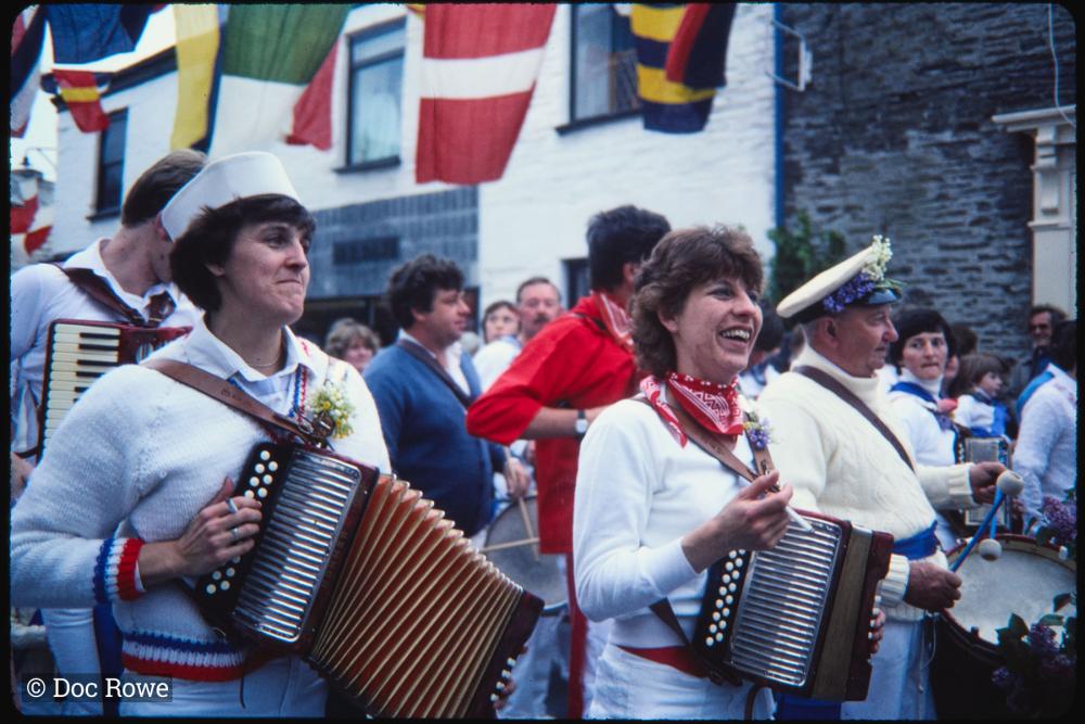 Women playing accordions in procession
