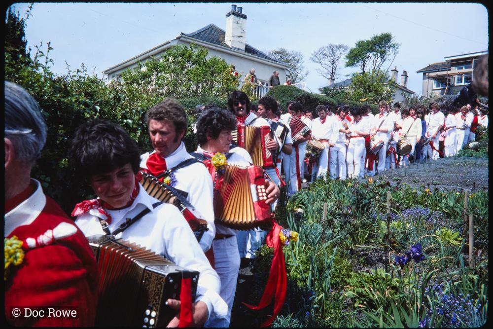 Old Oss band procession walking through garden