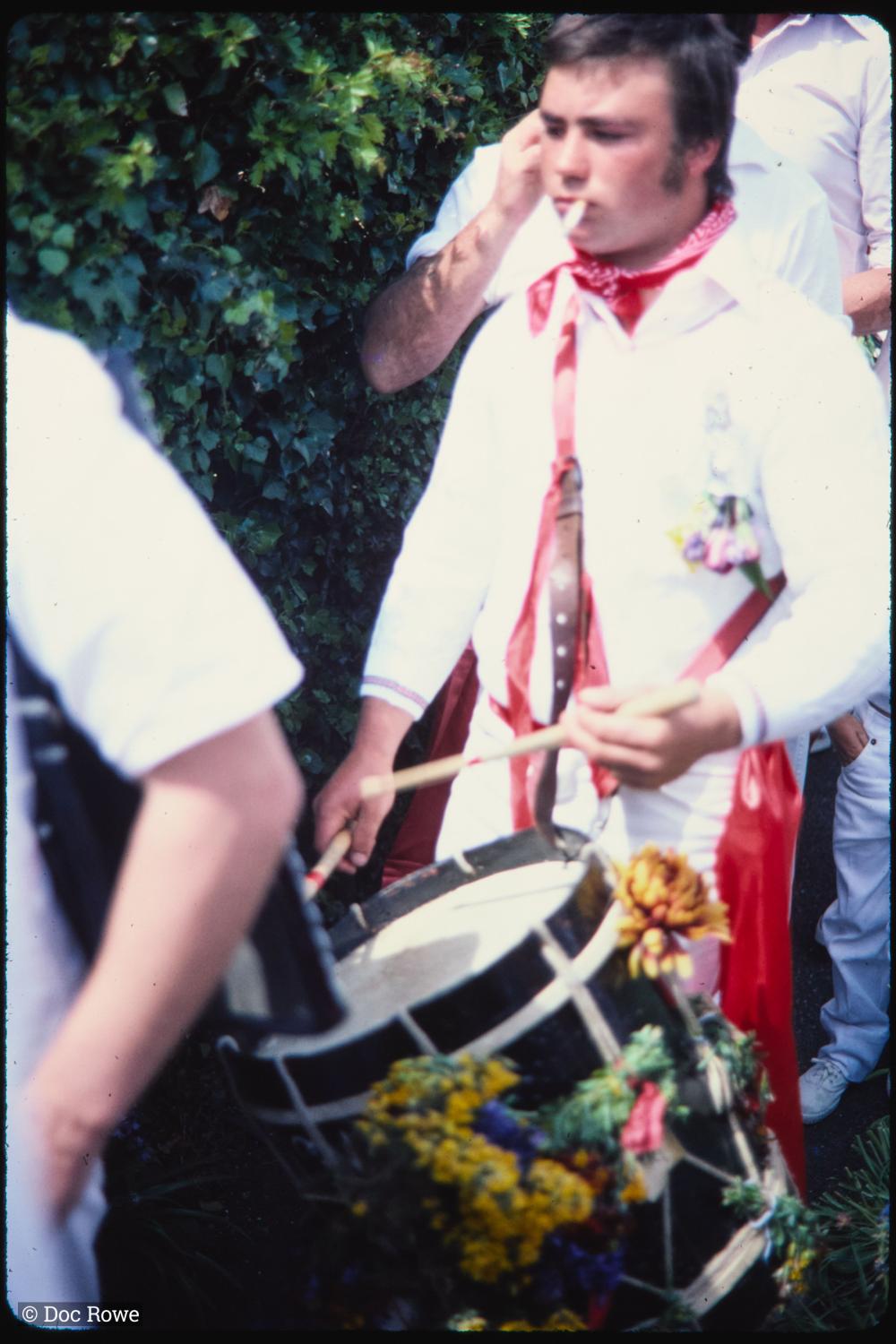 Old Oss band drummer walking through garden