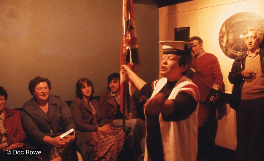 Woman singing, holding union flag