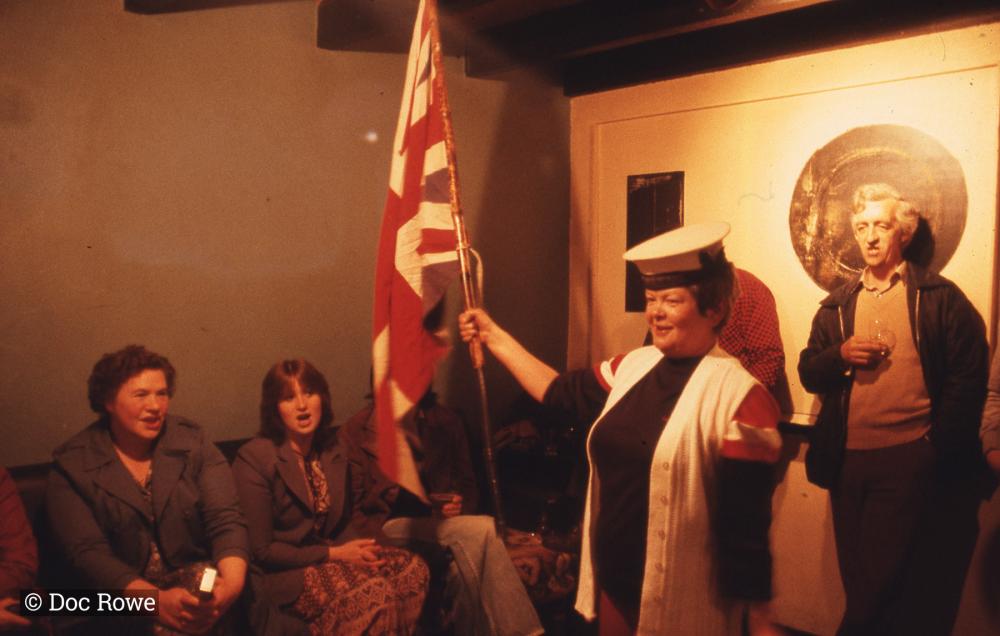 Woman singing, holding union flag