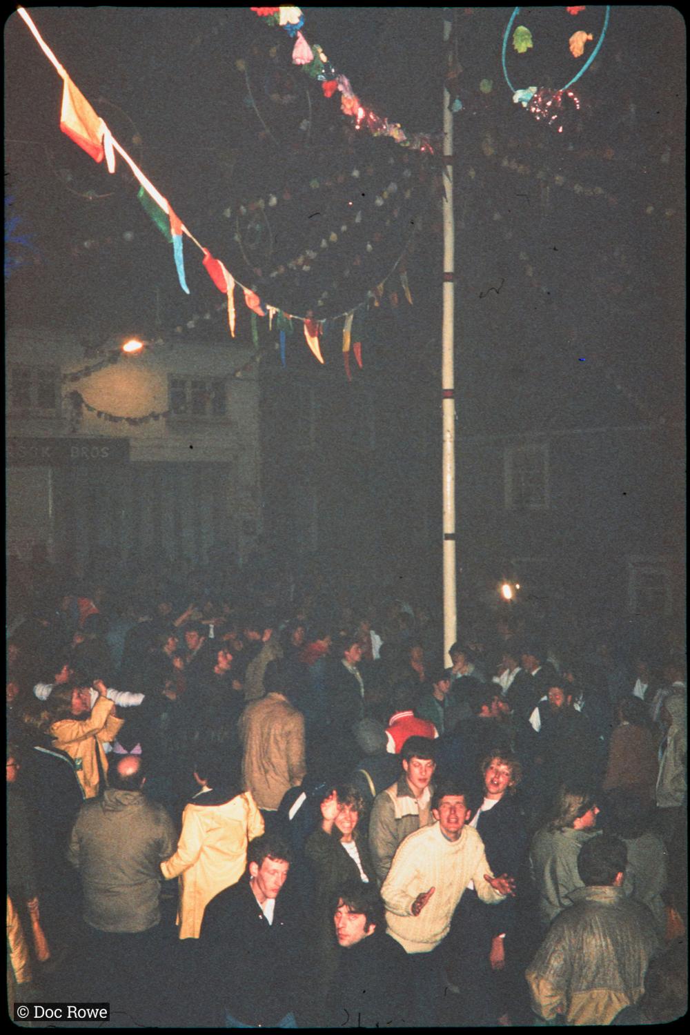 Crowd under maypole at night