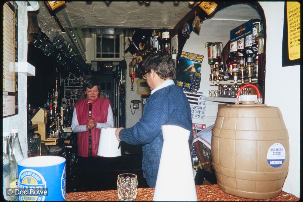 Landlords behind bar of pub 