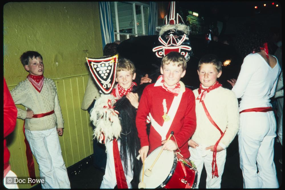 Children posing with Old Oss in pub