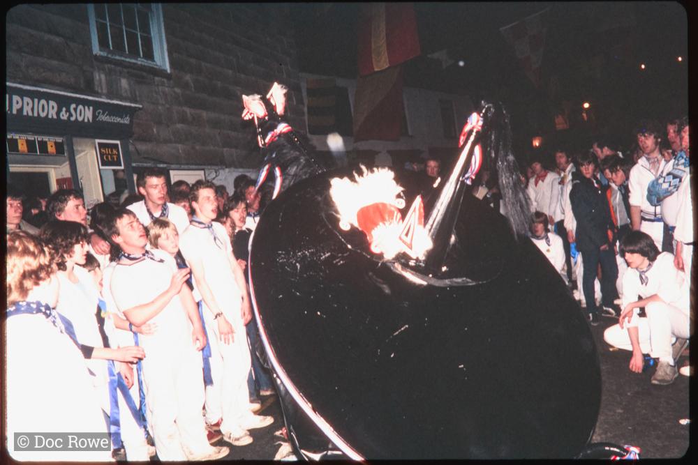 Blue Ribbon dancing at night with crowd watching