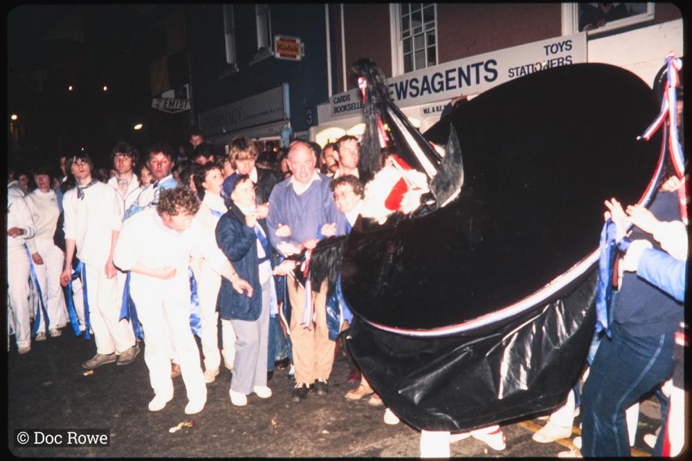 Blue Ribbon dancing at night with crowd watching