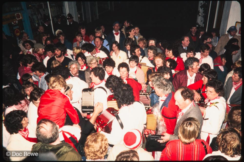Procession in very crowded Lanadwell street at night