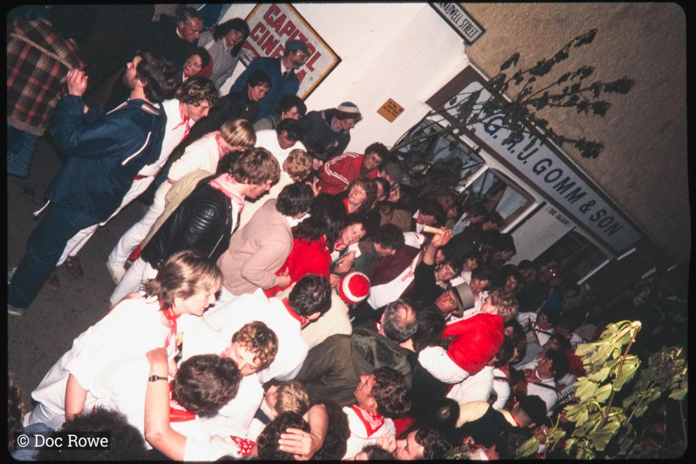 Procession in very crowded Lanadwell street at night