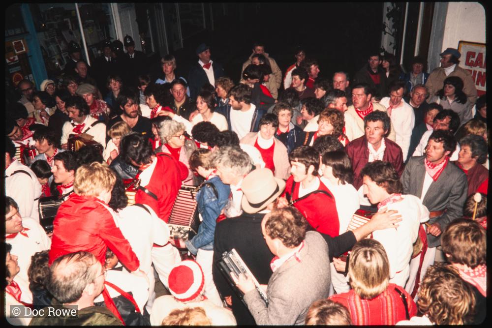 Procession in very crowded Lanadwell street at night