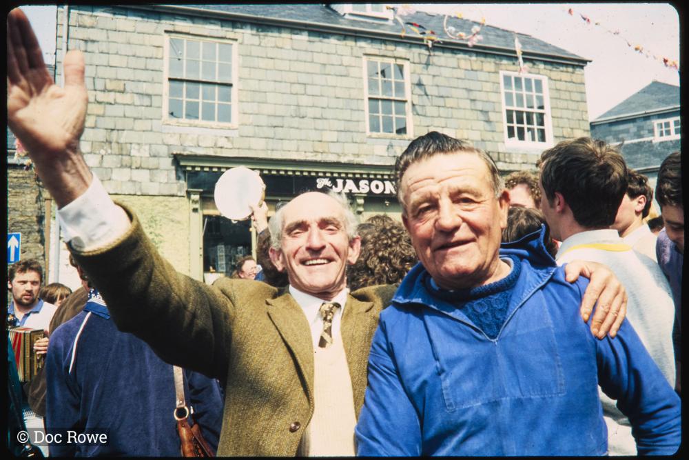 Men smiling under maypole