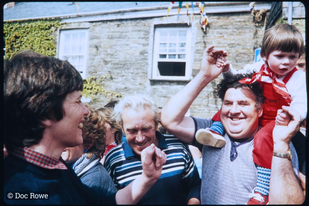 Man dancing with child on shoulders