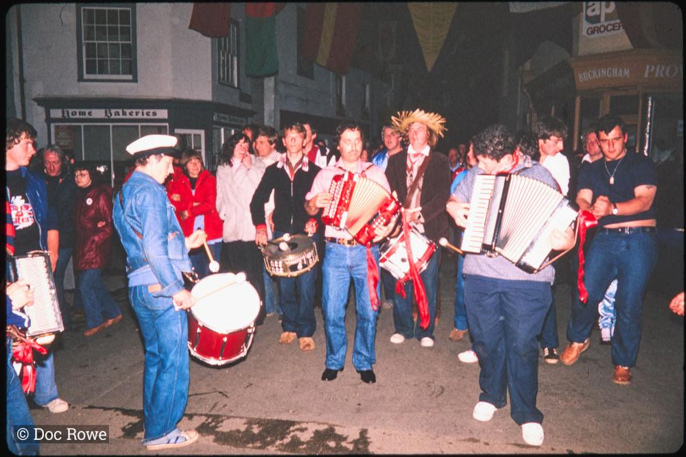 Musicians at night in street with crowd