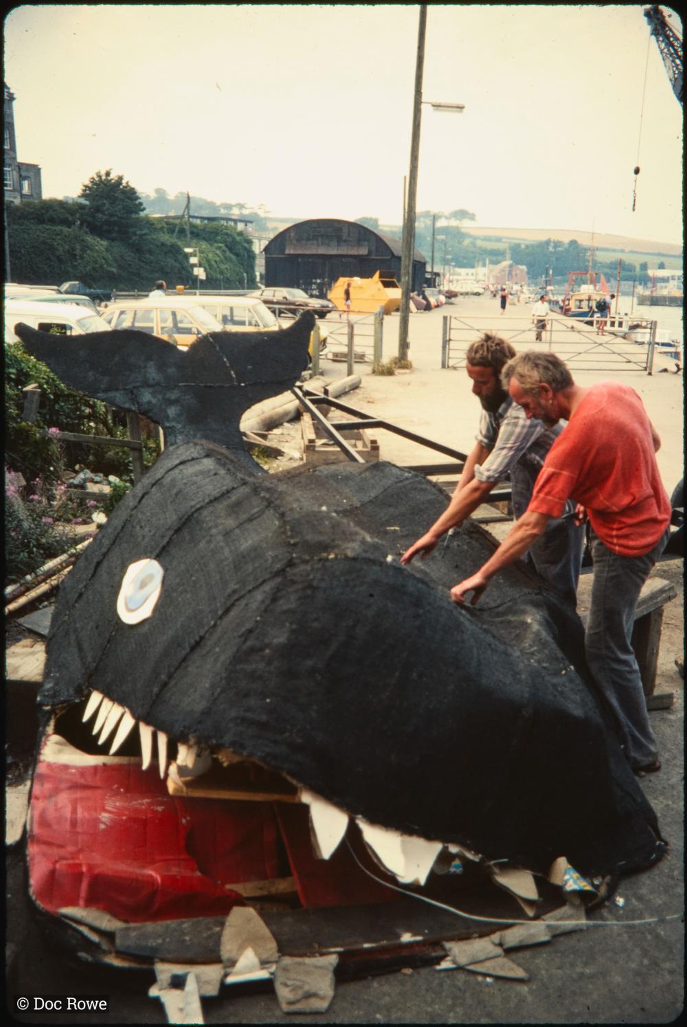 Men deconstructing carnival whale