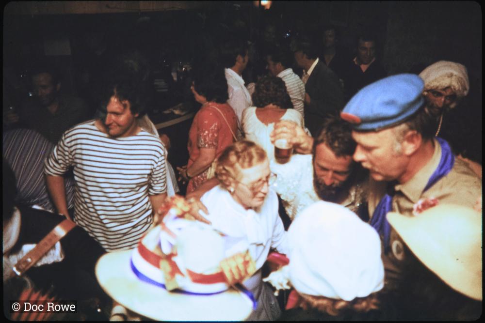 People dancing in fancy dress in pub