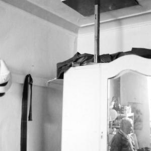 man in reflection of wardrobe mirror