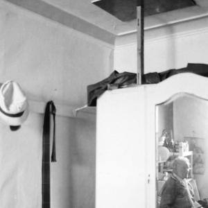 man in reflection of wardrobe mirror