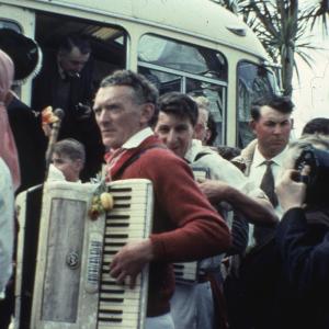 Accordion players getting off of a coach