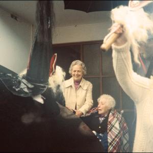 Old Oss greeting women at their door 