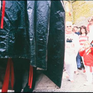 Child with teasing club, half photo obscured by oss