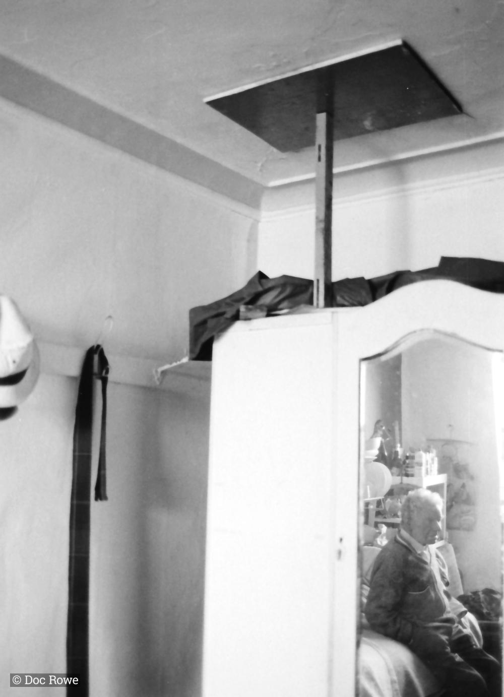 man in reflection of wardrobe mirror