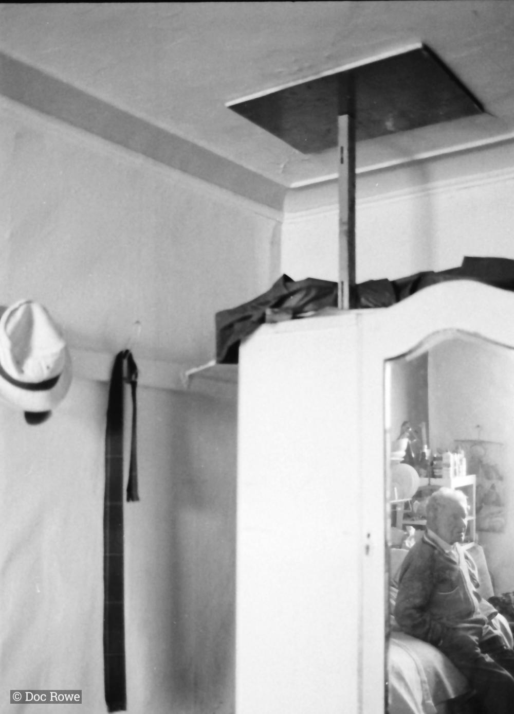 man in reflection of wardrobe mirror