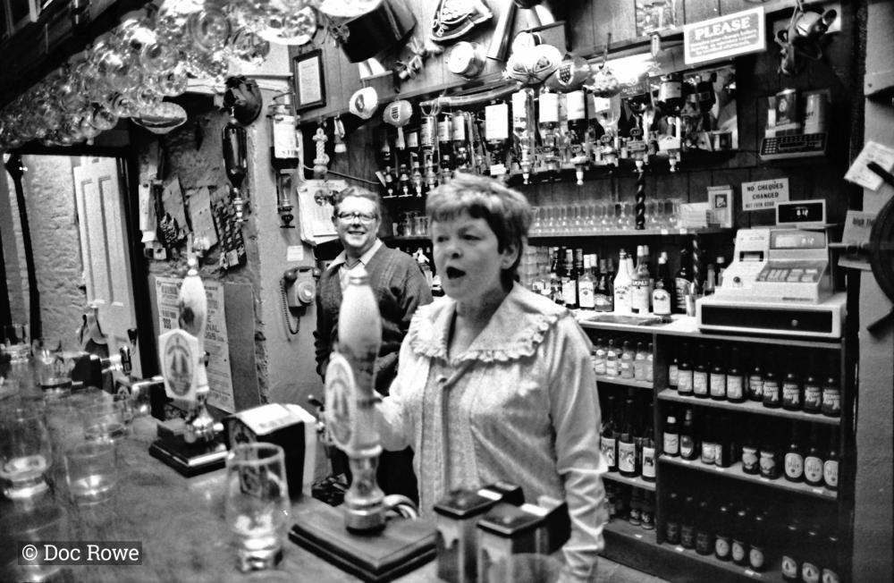 landlady behind bar in pub