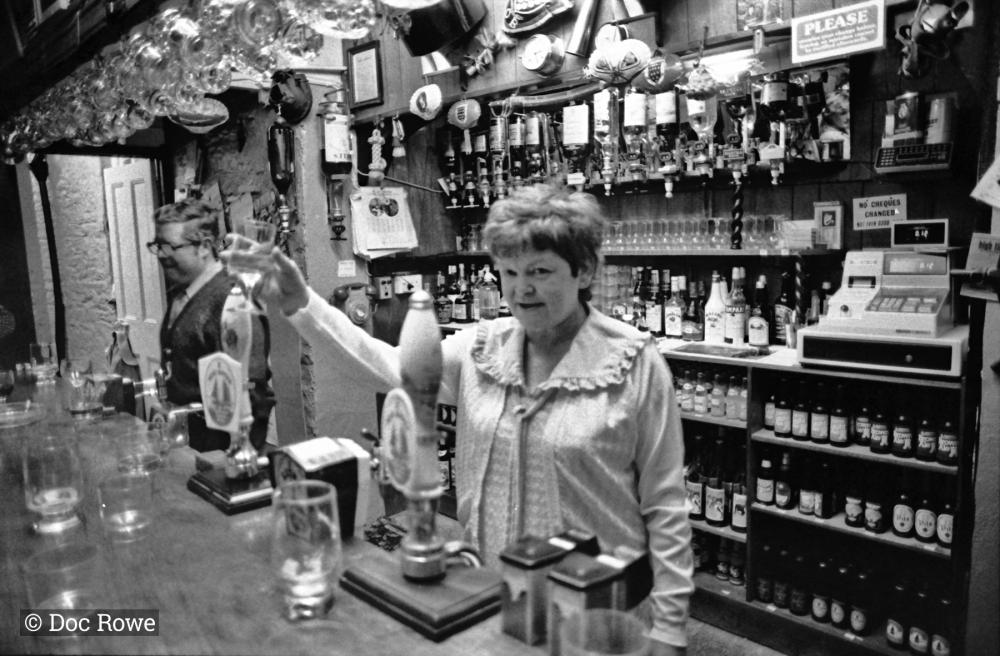 landlady behind bar in pub