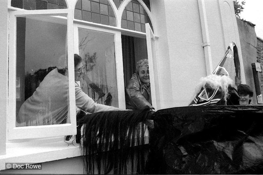 Old Oss being stroked by women from inside house