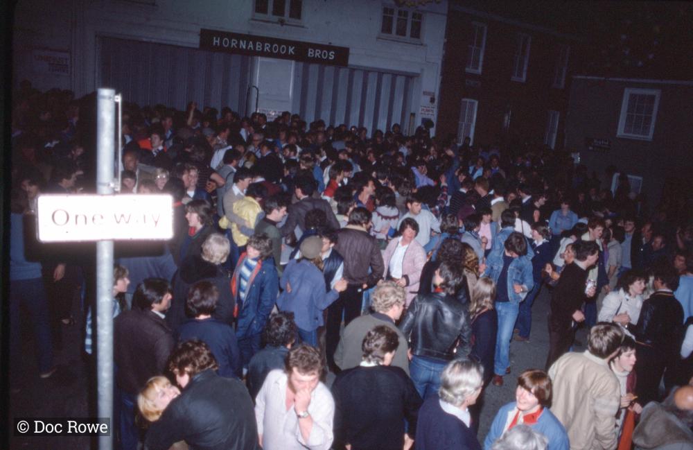 People under maypole at night