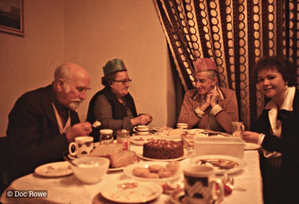 People sitting around the dining table at Christmas